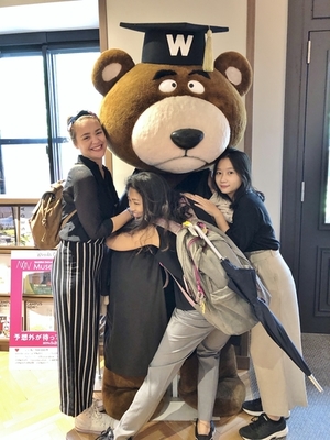 Students (left to right) Nathalie, Sally, and Thao with Waseda_s mascot Kuma Bear