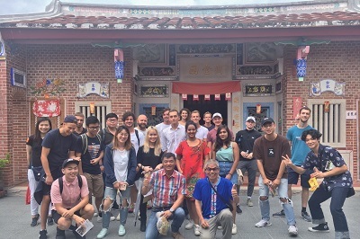 Exchange students taking a group photo in front of Hsiao Family Old House.