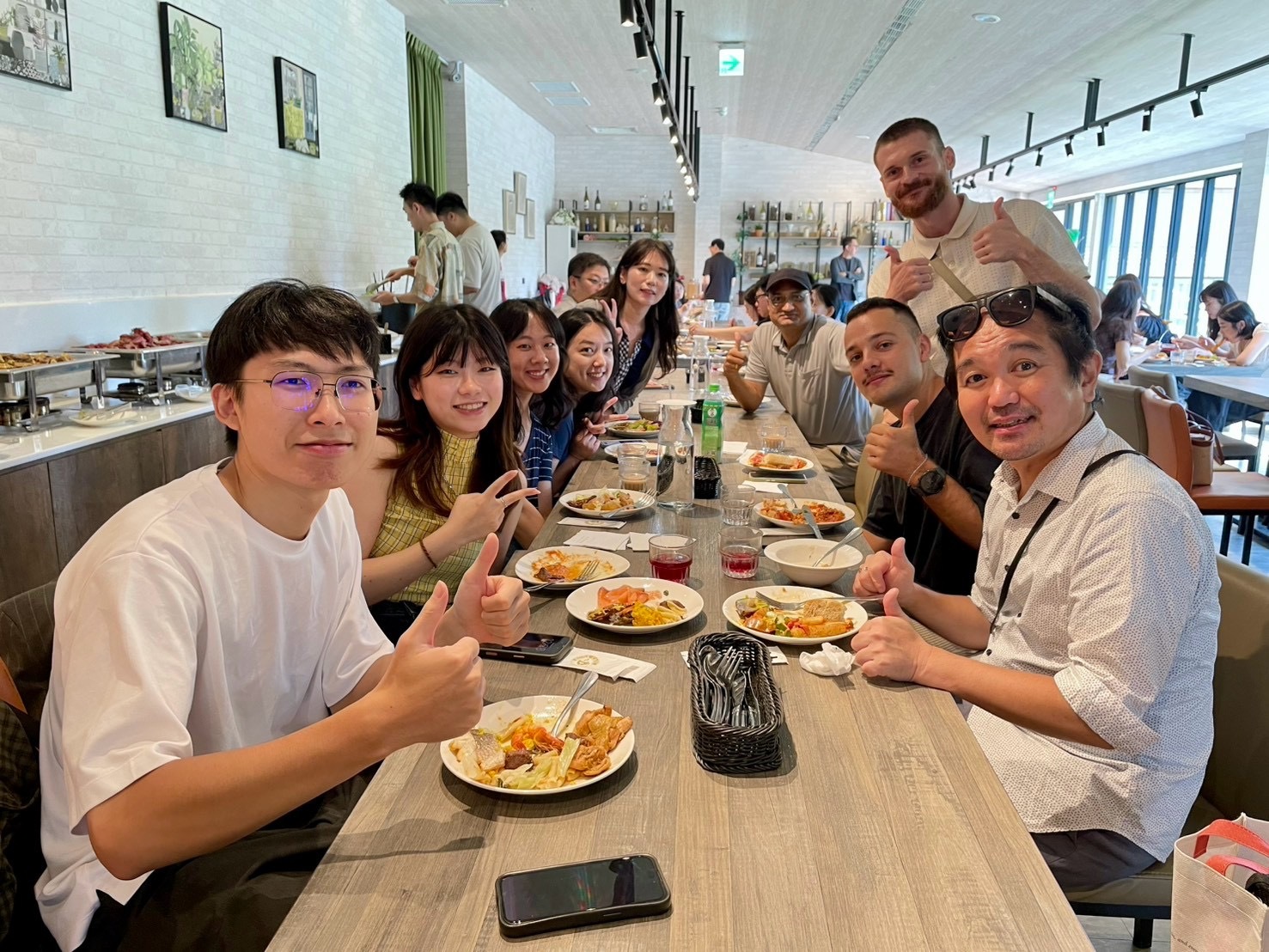 Alumni from diverse backgrounds enjoying lunch and networking together.Image