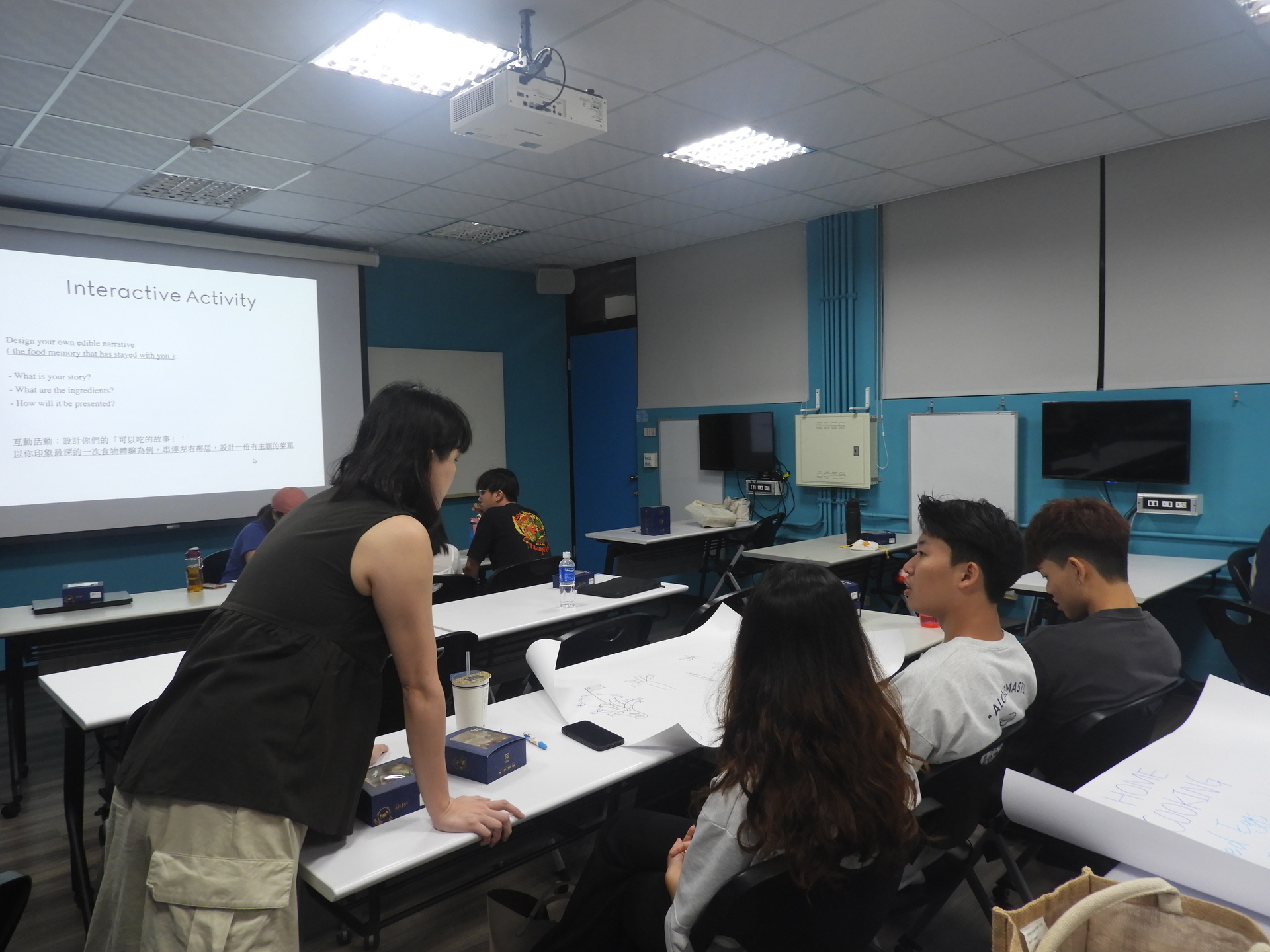 Students actively discuss their presentation ideas