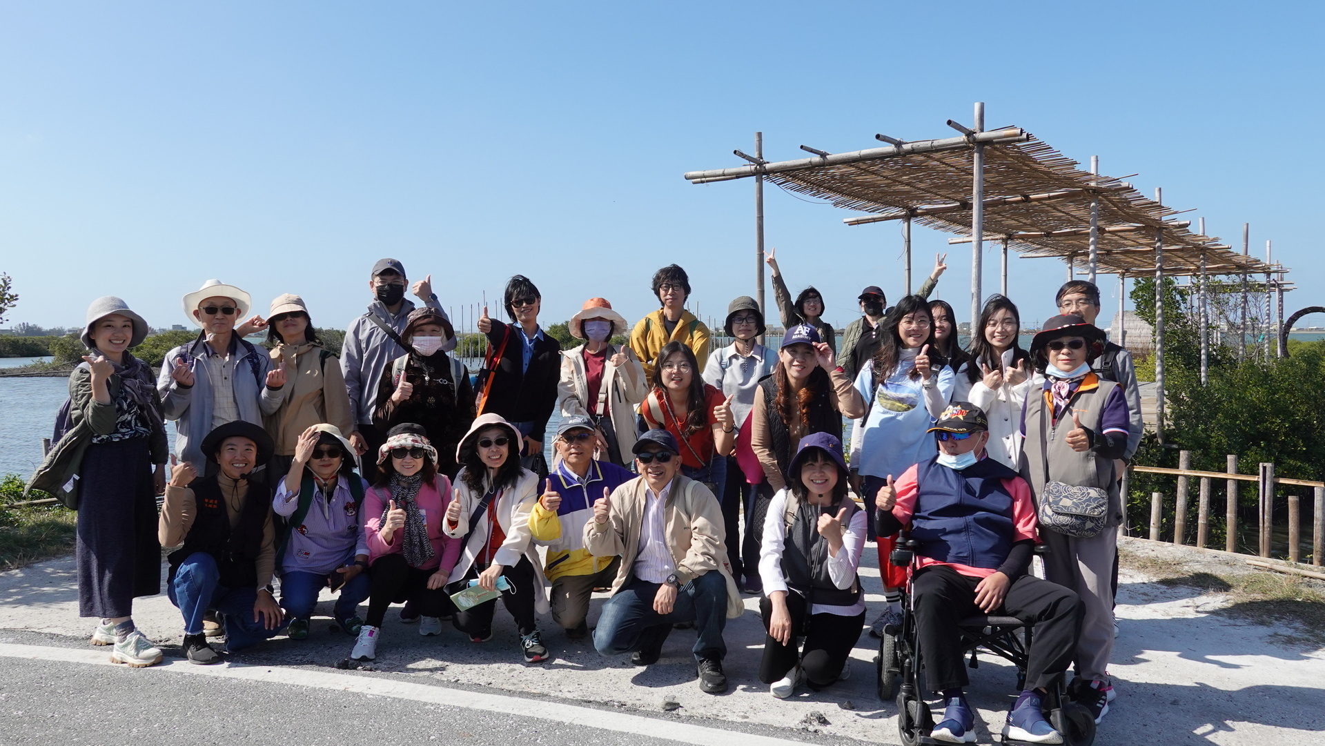 Group photo captured in front of the "Connection" art installation