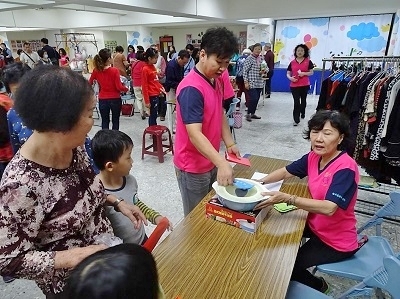 Community residents shop and buy products at a time bank store.