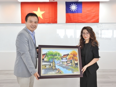 越南FPT代表Le Thanh Ngan(右)致贈越南當地風景畫給中山管院圖片