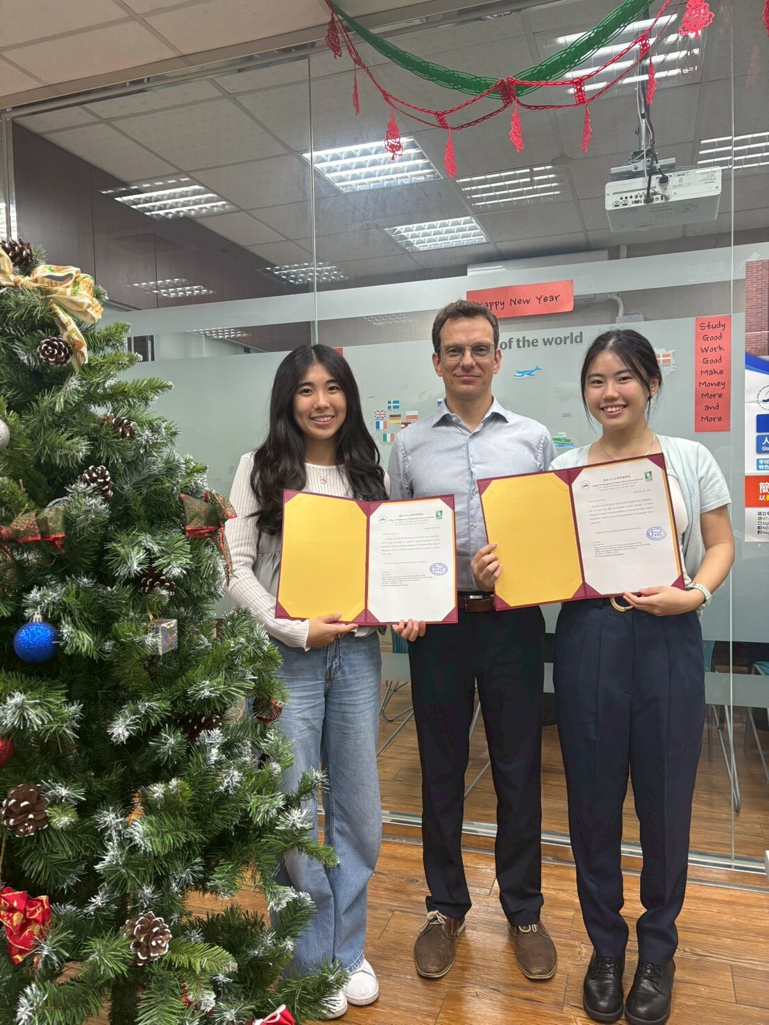 Director Timo Eccarius presented internship completion certificates to two interns.Image